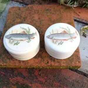 Two small jars of Patum Peperium 'The Gentleman's Relish' with fish on them.