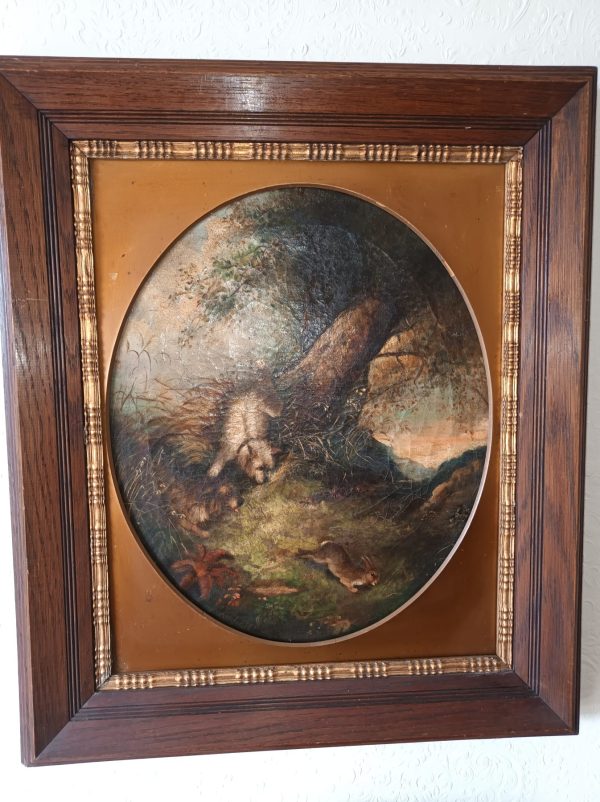 A framed painting of George Armfield Terriers Chasing Rabbit.