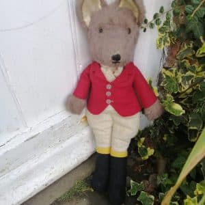 Super Example of Mr Fox dressed as Huntsman, wearing a red jacket and boots.
